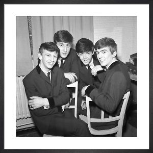 Girl Sitting Beside a Colorful Flower Display